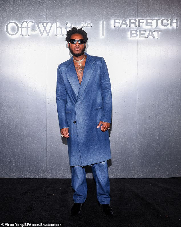 Bold in denim: Leon Bridges, 34, was also spotted at the event in a smart denim blue suit.  He was shirtless under a long-sleeved, long-lined blazer and matching slacks