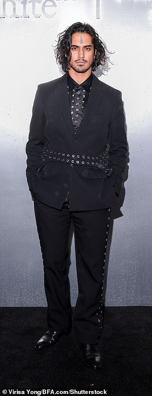 Studded: The Victorious actor also modeled a stylish black suit with matching silver detailing.  He wore a studded satin button-down under a blazer with a hoop-lined belt and matching trousers.