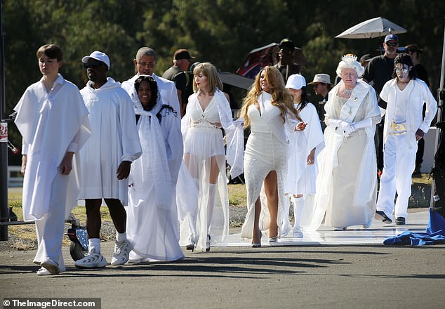 During the video shoot in Southern California, a line of celebrity impersonators were spotted wearing white ensembles