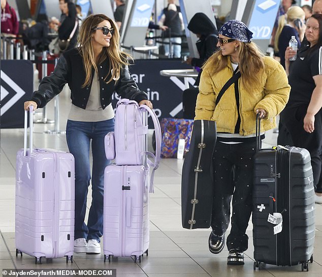The pair clutched their bags as they walked through the departure terminal