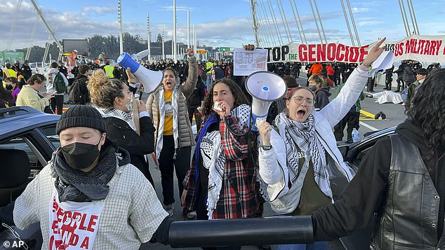 Protesters shout slogans after shutting down the San Francisco Oakland Bay Bridge in conjunction with the APEC summit