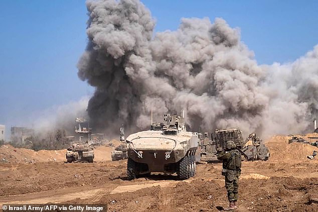 Israeli military vehicles and heavy smoke in the Gaza Strip