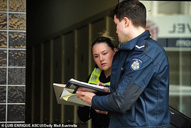 Homicide detectives are pictured at the scene following the alleged stabbing