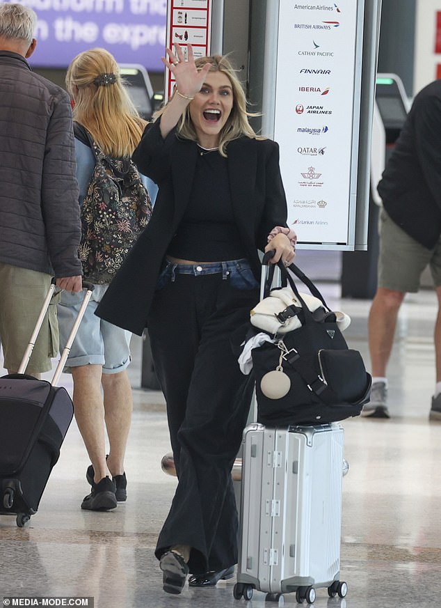 Emma beamed as she strolled through the terminal.  She looked chic in a black blazer and matching trousers with a fitted dark shirt underneath