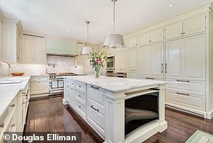 Granite countertops and white cabinets are just two features of this beautifully designed kitchen, complete with an island, three ovens and a vintage 1950s stove. It's great for any homeowner who wants to prepare a quick meal in style