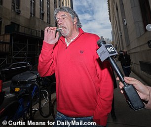 The 54-year-old appeared casually outside court on Wednesday, taking a drag on a cigarette