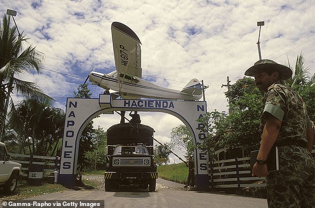 Colombian soldiers stand at the entrance of Hacienda Napoles, the estate built by Pablo Escobar where his own personal zoo was once