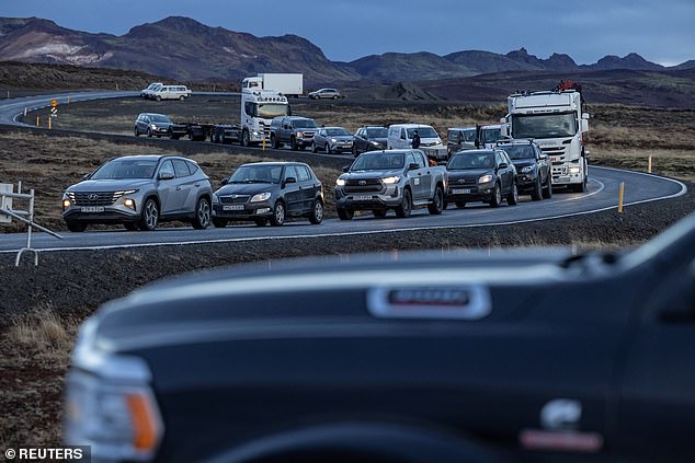 Local residents wait in their cars to gain access to their homes in the fishing village of Grindavik, which was evacuated on November 16 due to volcanic activity in Iceland.