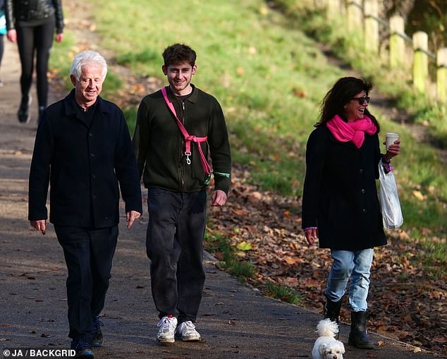 Happy days: On Thursday, the 66-year-old Love Actually and Notting Hill filmmaker and his wife, 61, stepped out for a dog walk in West London with their son Spike