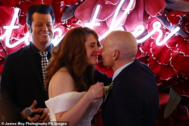 The happy couple prepared to share a kiss after being declared husband and wife