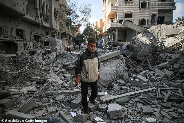 A man walks among the rubble of destroyed buildings after the Israeli attack on Nuseirat Camp, Gaza on November 17, 2023