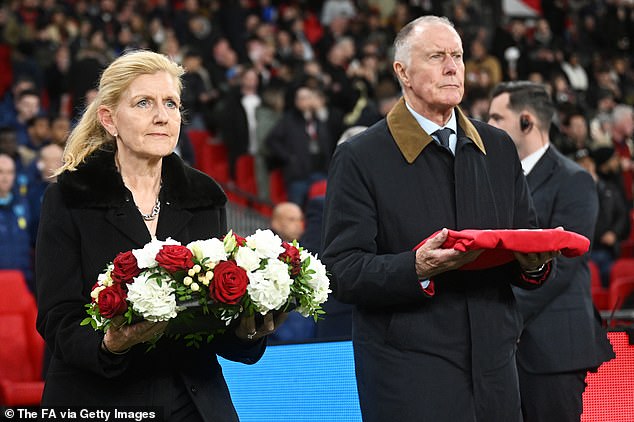 Sir Geoff Hurst (right) - the last living member of the 1966 World Cup-winning team - laid Sir Bobby's England shirt on the pitch and FA chairman Debbie Hewitt (left) laid a wreath