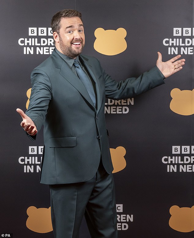 Playful: Jason Manford also posed on the red carpet in a green suit before taking the stage