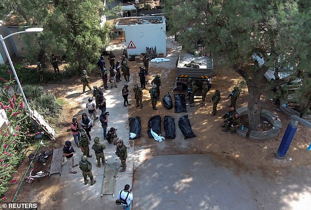 An aerial photo shows the bodies of victims of the Hamas attack on the Kfar Aza kibbutz on Tuesday