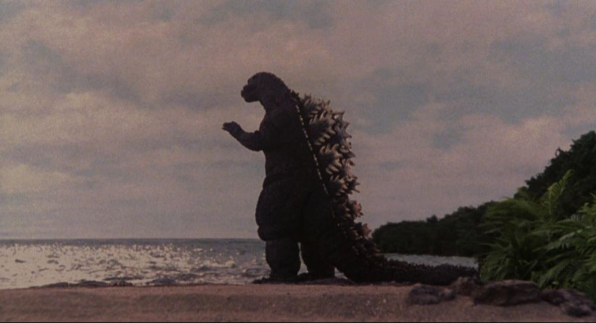 A shot of Godzilla standing on a beach looking out at the ocean from Godzilla vs. Space Godzilla