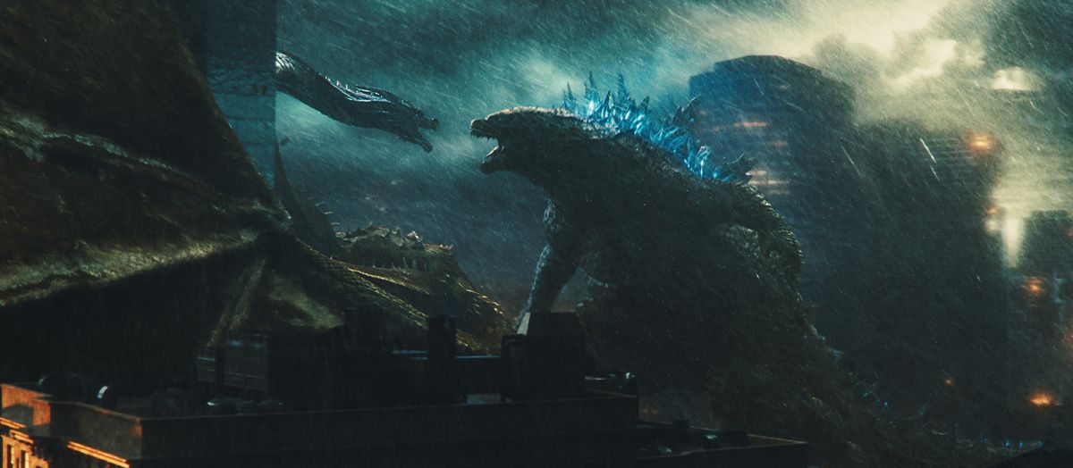 godzilla looking fierce at another monster against a rainy cityscape in Godzilla: King of the Monsters