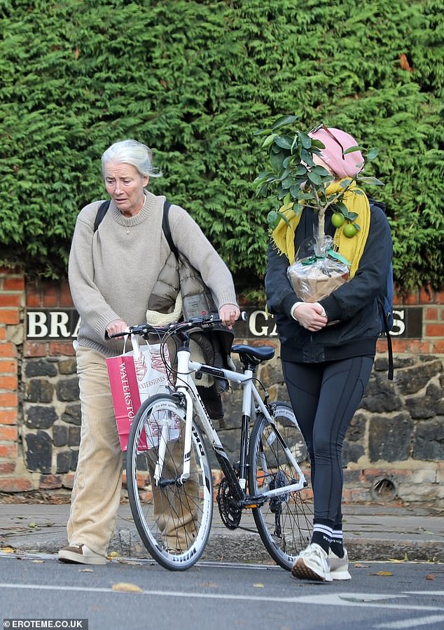 Stepping out: The Harry Potter star rocked cozy sneakers, keeping her comfortable on her morning walk as she pushed a bike with her