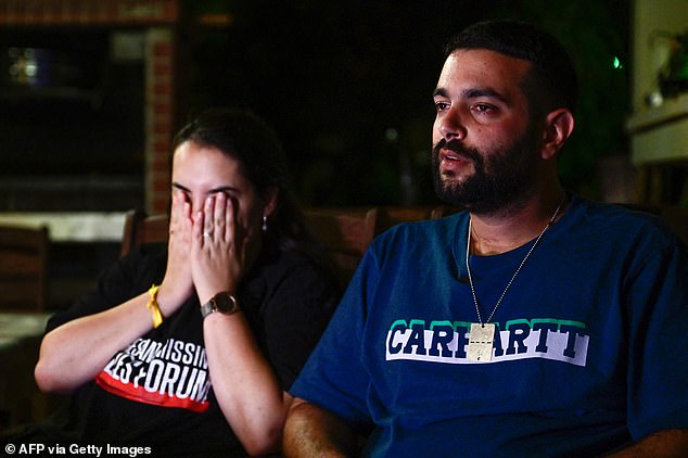 Omer and Zemer Weiss, the son and daughter-in-law of deceased Israeli hostage Yehudit Weiss, speak during an interview at their home in Moshav Olesh in central Israel, on November 17, 2023