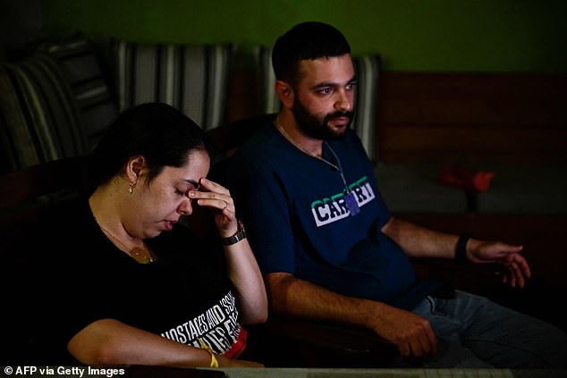 Omer and Zemer Weiss, the son and daughter-in-law of deceased Israeli hostage Yehudit Weiss, speak during an interview at their home in Moshav Olesh in central Israel, on November 17, 2023