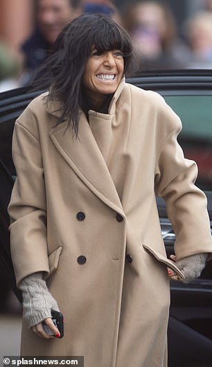 Match: Her co-star Claudia, 51, mirrored her in an equally chic brown coat and looked cheerful