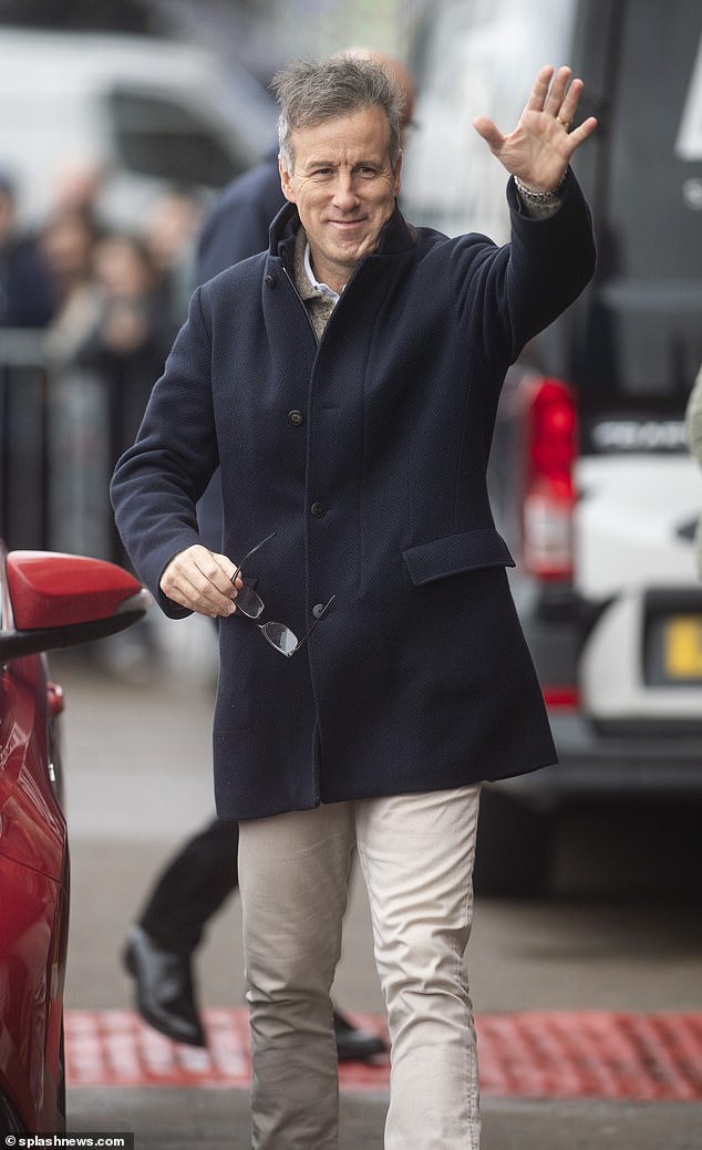 Making an entrance: The ballroom professional, 57, looked suave in a navy blue jacket and pigeon trousers as he cheered for the camera