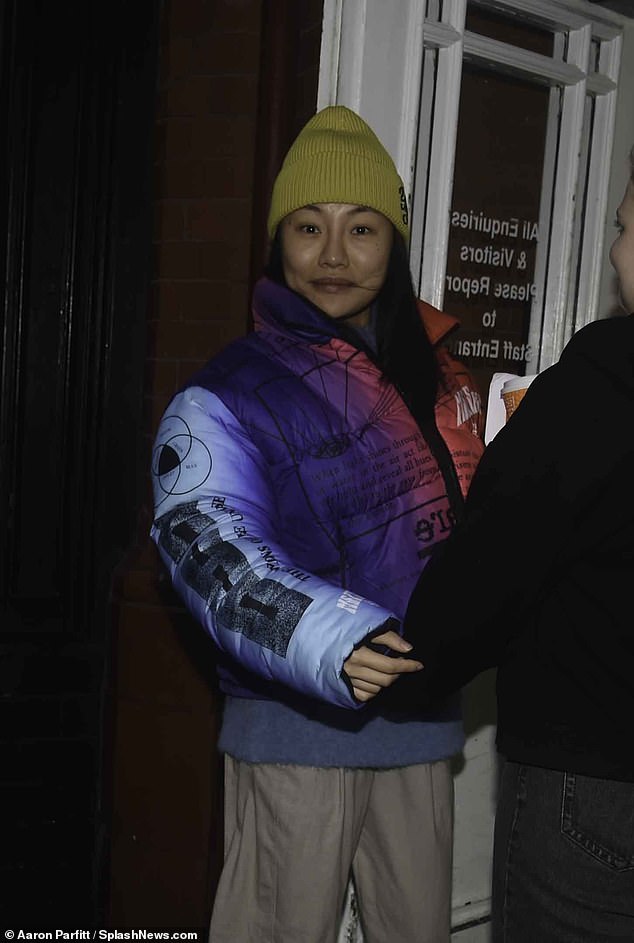 Staying warm: Nancy Xu, who came first in the competition with her partner Les Dennis, wrapped warm in a yellow beanie and puffer jacket