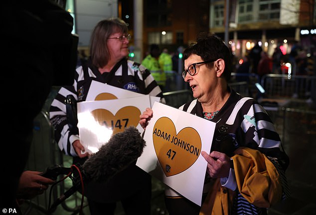 Fans gather with posters of Johnson ahead of a memorial match organized by former team Nottingham Panthers