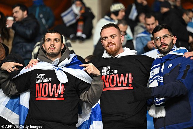 These Israeli fans wore shirts with the slogan 'bring them home now!'  written on it