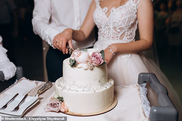 One couple was left $14,000 out of pocket when their caterer canceled the day before their wedding.  The photo shows a couple cutting a wedding cake