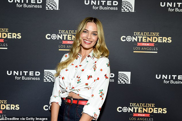 Stylish: The beauty was retro-chic and wore a cropped, white blouse with red floral details embroidered on the fabric and tied in a knot at the front