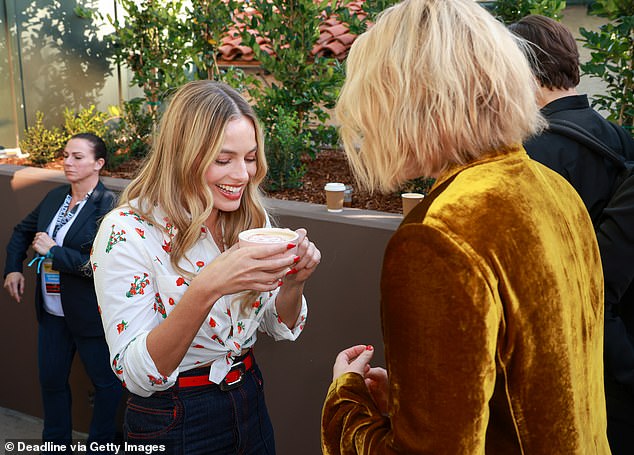 Delicious: When she wasn't on stage addressing the audience, Margot got the chance to enjoy a hot latte with her face decorated on it