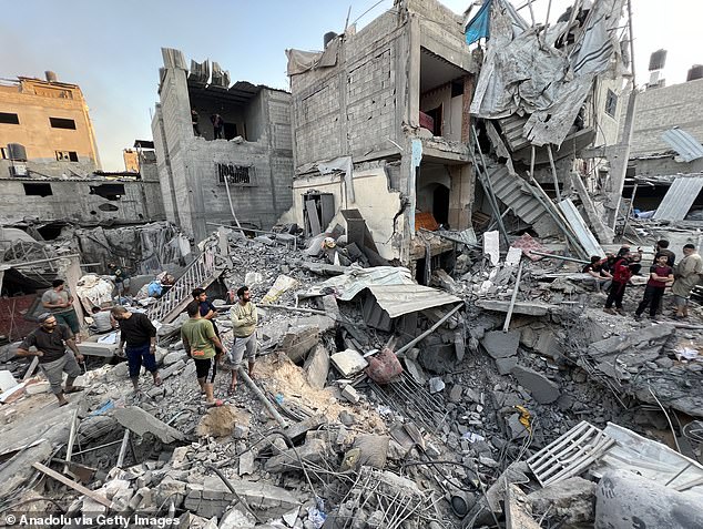 Civil defense teams, together with local residents, carry out search and rescue operations in the rubble of the residential buildings after Israeli strikes hit residential buildings in the Jabalia camp in Jabalia, Gaza on November 18, 2023