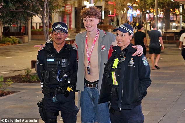 Either this schoolboy (photo) is very tall, or the police officers he poses with are not