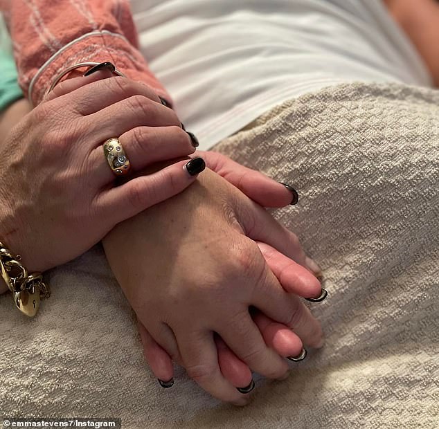 Emma Stevens shared the above photo in May of her holding her sister's hands as she passed away