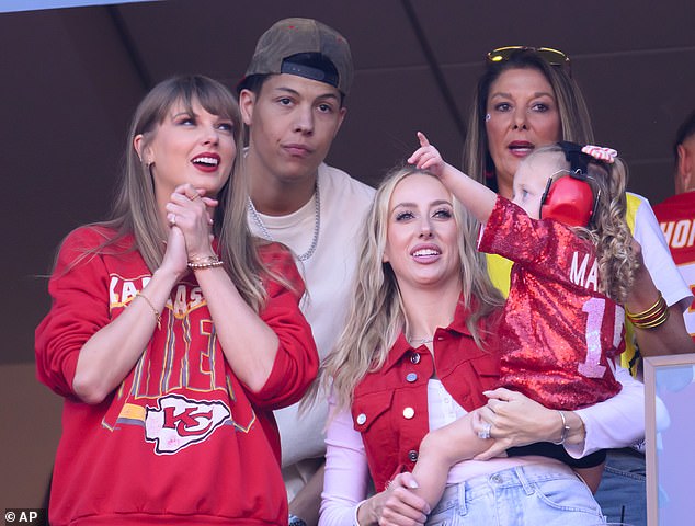 Taylor Swift, left, and Brittany Mahomes, right, watch an NFL football game between the Kansas City Chiefs and the Los Angeles Chargers with Jackson Mahomes, back left, and Randi Mahomes, back right