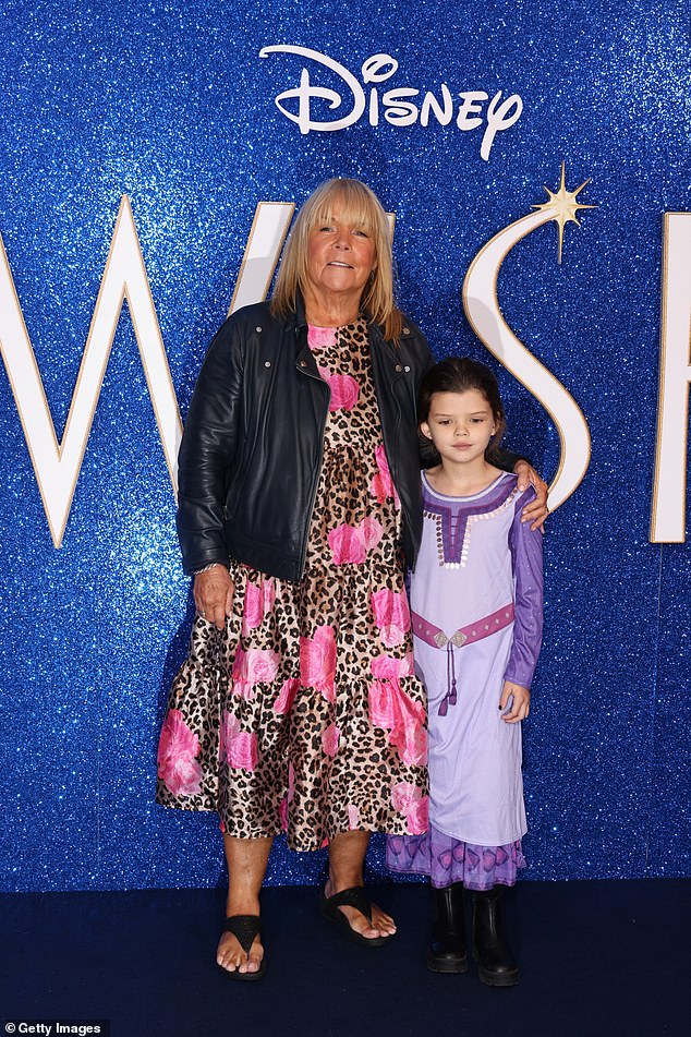 Looking good: Linda looked effortlessly stylish at the film screening in an animal print maxi dress adorned with pink roses