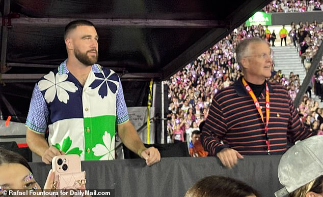 Supporting beau: Travis Kelce sent Taylor Swift fans wild after she appeared with her father Scott (right) in a VIP tent during her Eras tour in Argentina on Saturday night at Estadio River Plate