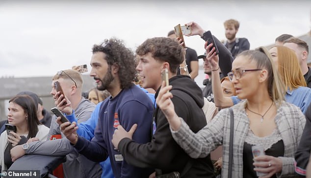 A crowd watches a fight at the King of the Ring fight club in Manchester