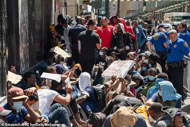 Migrants wait outside the Roosevelt Hotel to be processed on August 2.  Since spring 2022, more than 118,000 have flooded New York City, a “sanctuary city”