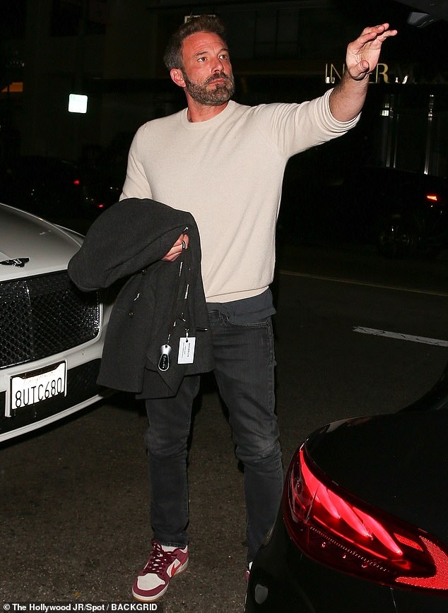 Taking it easy: Affleck wore a beige crew-neck sweater, which contrasted with skin-tight black jeans