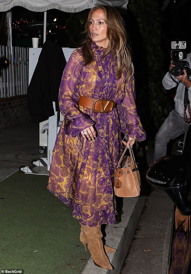 All dressed up: The singer, who recently supported her husband at a charity event in Las Vegas, wore a flowing Burberry dress with a purple and yellow floral print, which was accentuated by a chunky Valentino belt