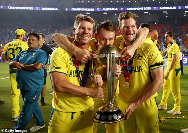 Pictured from left to right: Warner, Marnus Labuschagne and Steve Smith celebrate with the World Cup trophy after their victory over India