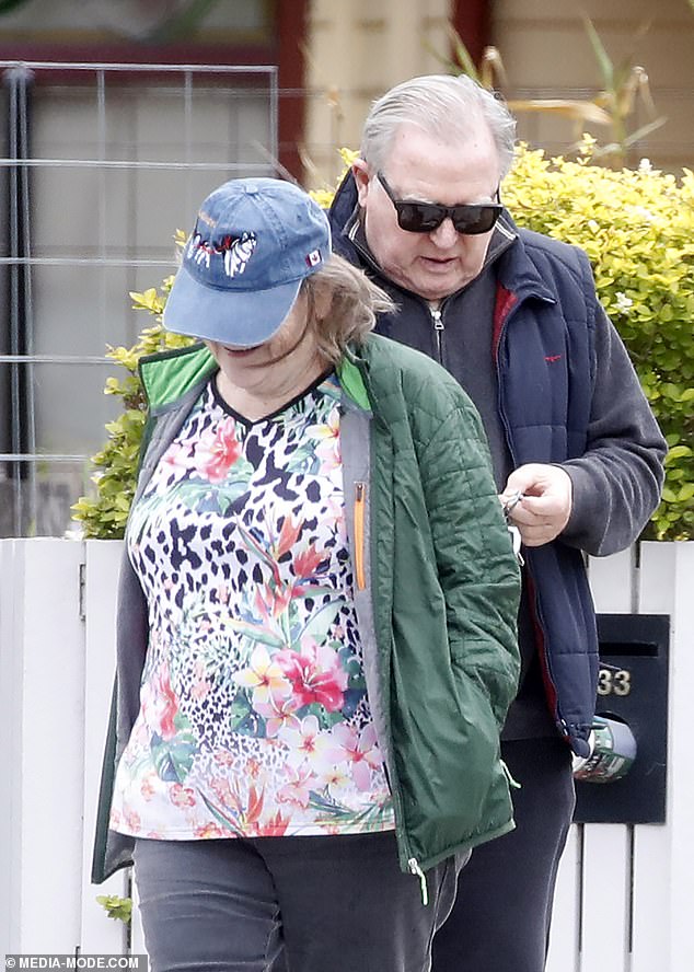 Hitchener wore sweatpants, a gray sweater and a cardigan as he was joined by a woman for an afternoon walk