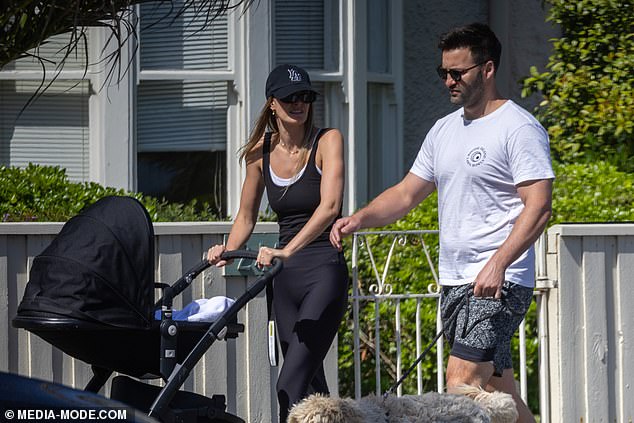 Amelia pushed seven-month-old Paloma in her stroller and enjoyed a sunny walk with Jimmy, who donned a more summery outfit.