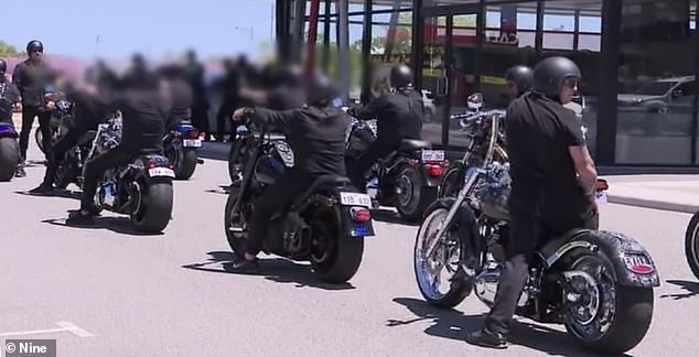 A column of rebel bikers was seen escorting the coffin of their fallen president Jamie Ginn to his funeral after the father-of-two suddenly dropped dead at a police station