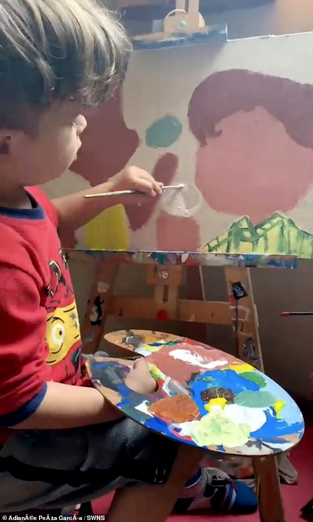 Little Santiago Daniel, who is now four years old, sits with paintbrushes and a canvas every day