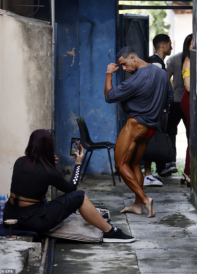 One participant flexes his muscles for the camera before taking the stage