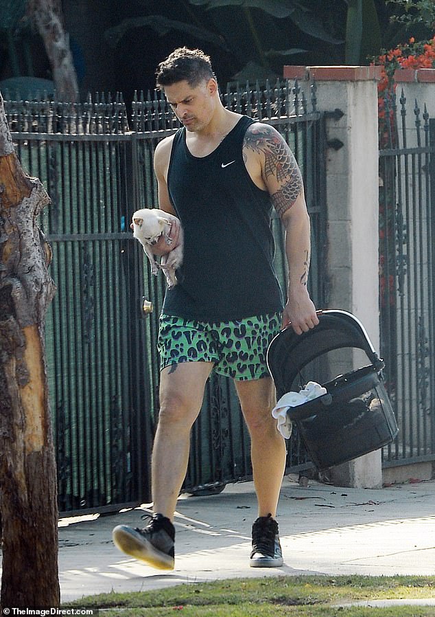 Muscular: The Kill Room star wore a black Nike tank top that showed off his toned and tattooed deltoids, along with a pair of green and black animal print shorts and black sneakers