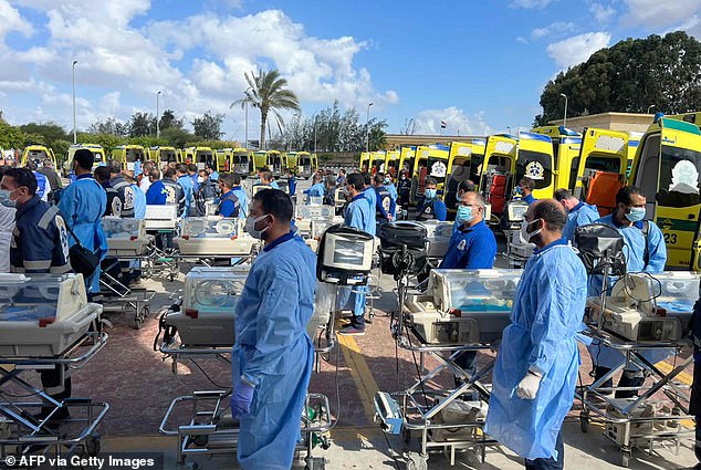 Under the watchful eyes of the UN and the Israeli army, a fleet of ambulances can be seen carrying out the crucial operation across the border at Rafa to hospitals in Egypt.
