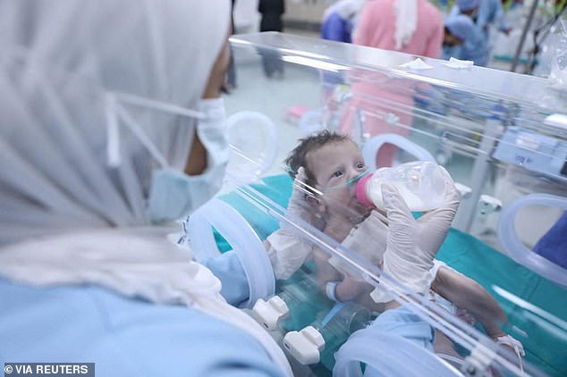 A premature Palestinian baby evacuated from Gaza is fed